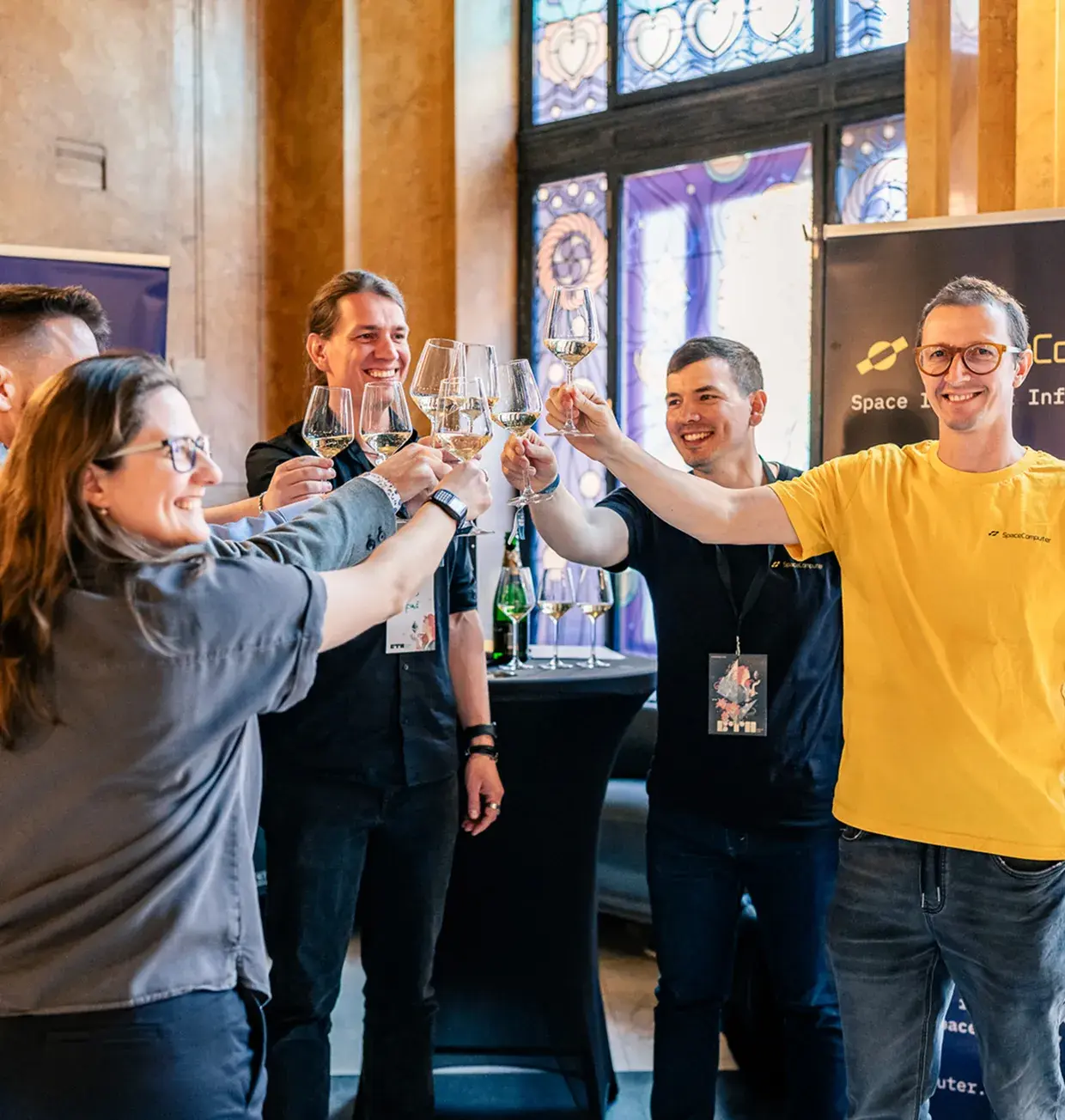 Team members toasting with wine glasses at a networking event