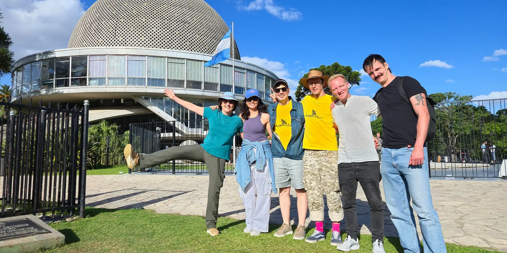 SpaceComputer team posing in front of the Buenos Aires planetarium dome